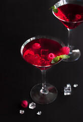 Red alcohol raspberry cocktails in martini glass with mint. Selective focus.