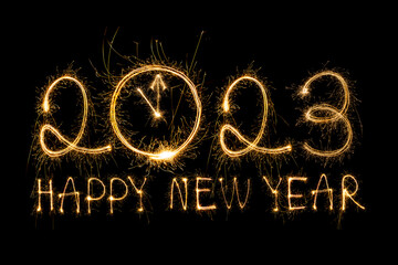 Happy New Year 2023. Sparkling burning text Happy New Year 2023 isolated on black background. Beautiful Glowing golden overlay object for design holiday greeting card