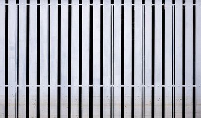 A white picket fence with flood stains.