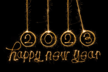 Happy New Year 2023. Sparkling burning text Happy New Year 2023 isolated on black background....