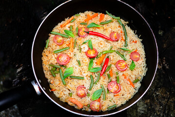 fried rice with shrimp, tomatoes and asparagus in a frying pan