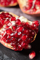 ripe red pomegranate fruit on table