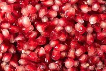 Pomegranate seeds background texture. Ripe red berries.