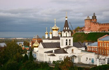 Orthodox old church against the backdrop of the Nizhny Novgorod Kremlin in autumn at sunset