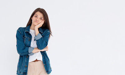 Image of sad casual girl, woman sulking and frowning disappointed, standing upset and distressed against white background
