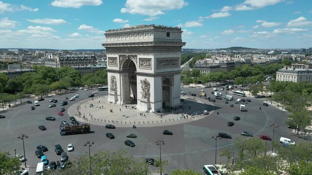 Triumphal arch and car traffic on roundabout, Paris in France. Aerial drone view