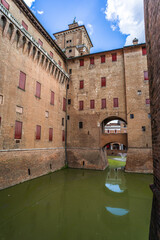 wide-angle close-up of the brick building of the Castle d'Este in Ferrara