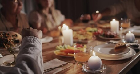 A large family has a festive dinner in honor of Thanksgiving, they sit at the festive table with delicious food - Powered by Adobe