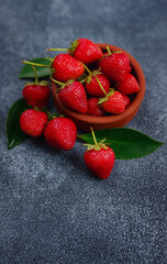 Fresh organic strawberries , over dark background. Vegetarian healthy food concept.
