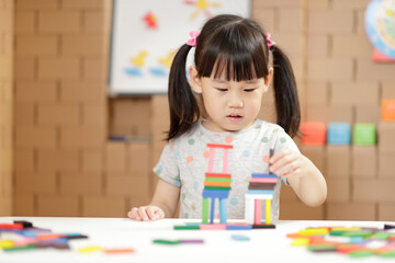 young girl play number sticks fine motor skill game for homeschooling