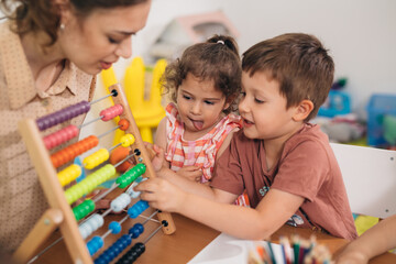 teacher teaching children in daycare