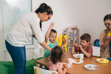children have breakfast in daycare - obrazy, fototapety, plakaty