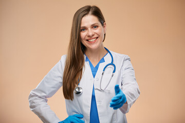 Woman doctor in white coat wearing blue gloves making handshake. Isolated portrait.