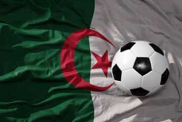 vintage football ball on the waveing national flag of algeria background. 3D illustration - obrazy, fototapety, plakaty
