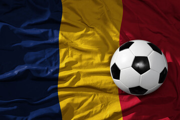 Naklejka premium vintage football ball on the waveing national flag of chad background. 3D illustration