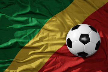 vintage football ball on the waveing national flag of republic of the congo background. 3D...