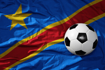 vintage football ball on the waveing national flag of democratic republic of the congo background....