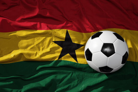 vintage football ball on the waveing national flag of ghana background. 3D illustration