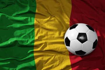 vintage football ball on the waveing national flag of mali background. 3D illustration