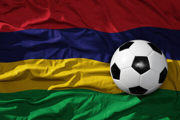 Naklejka premium vintage football ball on the waveing national flag of mauritius background. 3D illustration