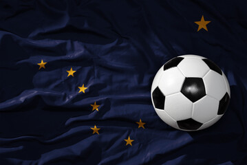vintage football ball on the waveing alaska state flag background. 3D illustration