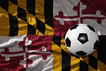 vintage football ball on the waveing maryland state flag background. 3D illustration