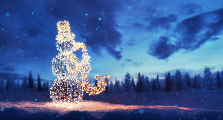 Christmas snowman garland lights in snow winter scenery
