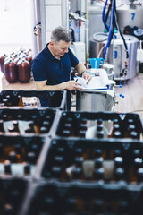 Man preparing craft beer from brewery for shipment.