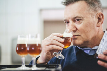 Man tasting craft beer from brewery.