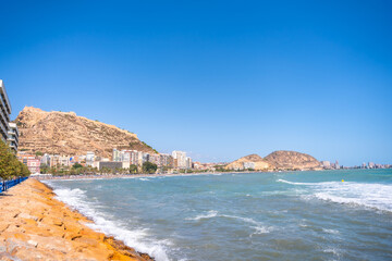 Postiguet beach in the city of Alicante on a summer afternoon and the Castle of Santa Barbara
