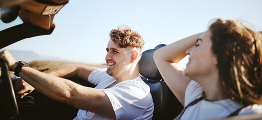 Road trip, happy couple and travel while in a convertible car for fresh air, adventure and journey...