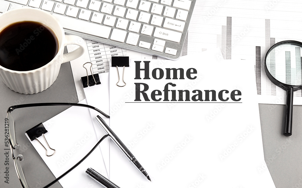 Poster home refinance text on a paper with magnifier, coffee and keyboard on grey background