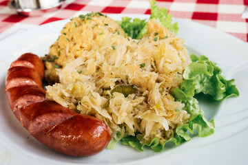 Traditional dish in Slovenia - kranjska klobasa (pork sausage) with mashed pea puree and stewed cabbage