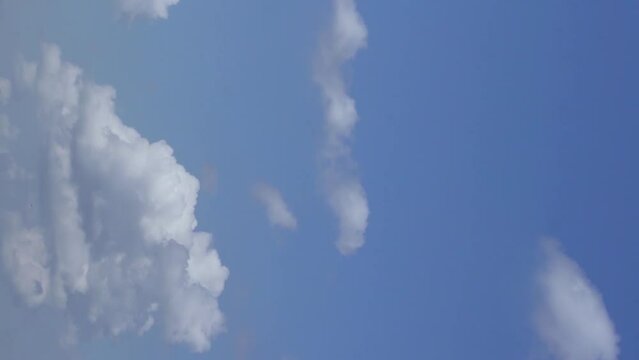 Vertical Footage. Time Lapse of White Fluffy Puffy Clouds Floating across the Blue Sky. Clouds and Sky during the Day in Clear Cloudy Weather. Clean air in the Atmosphere. Vertical Natural Backgrounds