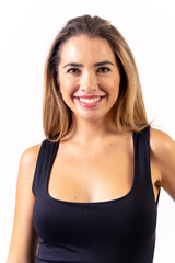 Fototapeta premium Portrait of a blonde woman in a black tank top on a white background, smiling looking at the camera
