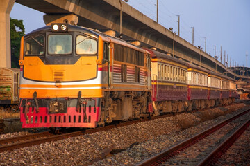 Passenger train by diesel locomotive at the railway station.