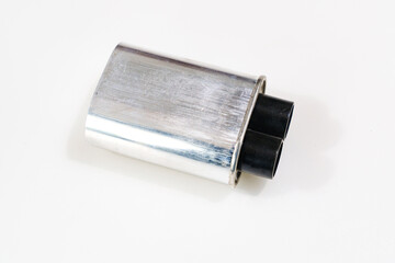 High-voltage capacitor on a white background. Part of microwave oven 