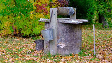 The old homestead well. Well, about water. The main source of water for agriculture. Sunny autumn day. Old retro looks traditional good.