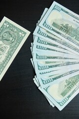 American currency dollars in one dollar and one hundred dollar bills. The concept of wealth and poverty, comparison of prices and payments.