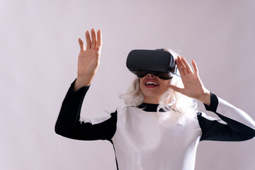 Close-up of adult woman gesturing with virtual reality glasses, metaverse on a white background