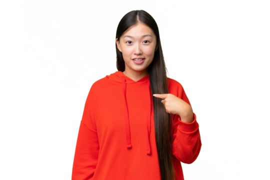 Young Asian woman over isolated background covering mouth and looking to the side