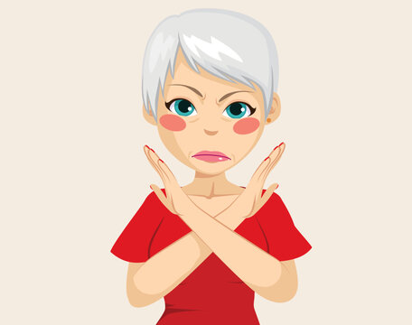 Senior woman making refuse gesture with crossed arms. Stressed adult lady feeling angry