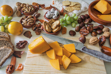 Table with a variation of autumn fruits. Background with fruit, nuts and pumpkin. All Saints Day.