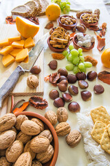 Table with a variation of autumn fruits. Background with fruit, nuts and pumpkin. All Saints Day.