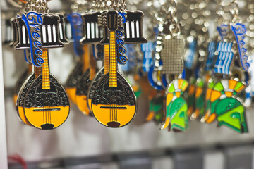 View of traditional tourist souvenirs and gifts from Athens, Attica, Greece with fridge magnets with text "Greece", "Athens" and key ring keychain, in local vendor souvenir shop in Monastiraki