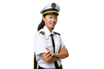 Airplane pilot Asian woman over isolated background with arms crossed and looking forward
