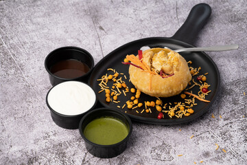 Rajasthani Shahi Raj-Kachori, stuffed with potato and sprout filling. served with curd, chutney and sev in a plate