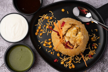 Rajasthani Shahi Raj-Kachori, stuffed with potato and sprout filling. served with curd, chutney and sev in a plate - obrazy, fototapety, plakaty