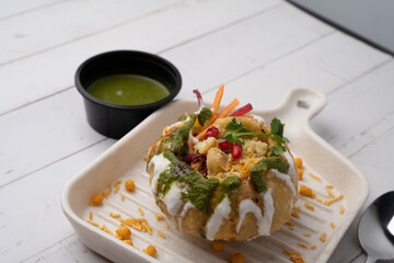 Rajasthani Shahi Raj-Kachori, stuffed with potato and sprout filling. served with curd, chutney and sev in a plate