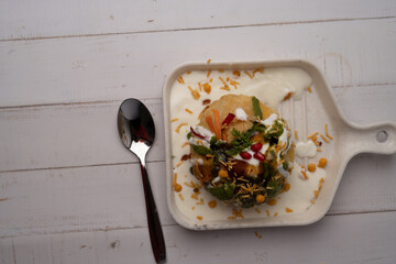 Rajasthani Shahi Raj-Kachori, stuffed with potato and sprout filling. served with curd, chutney and sev in a plate © Ojas